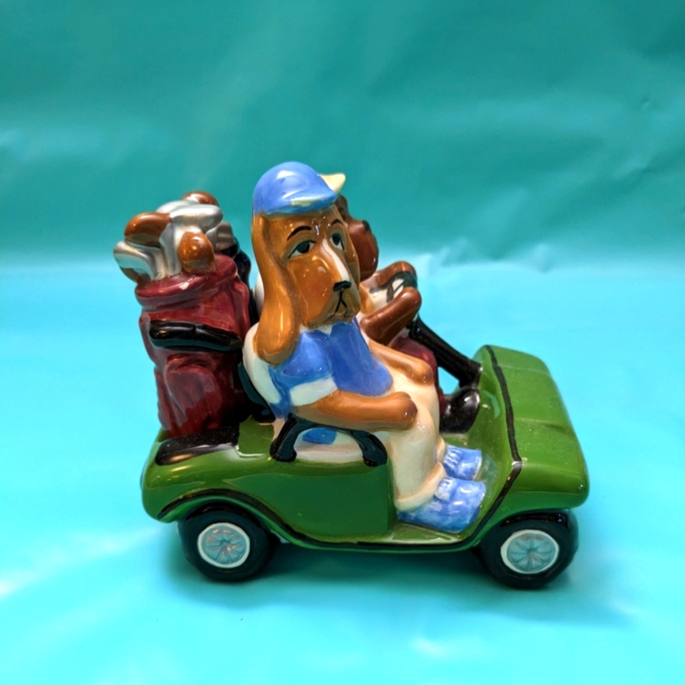 Vintage salt and pepper shaker. Two dogs driving a golf cart with golf clubs.